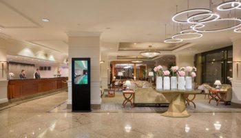 InterContinental Budapest lobby. Gay-friendly, pet-friendly hotel's interior with reception, seating area, and flower decorations. Upscale ambiance.