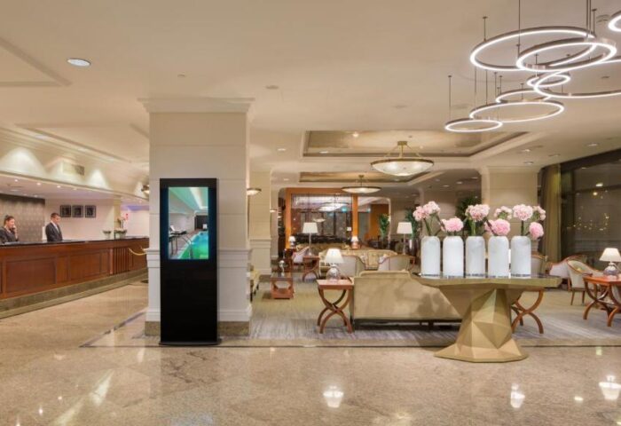 InterContinental Budapest lobby. Gay-friendly, pet-friendly hotel's interior with reception, seating area, and flower decorations. Upscale ambiance.