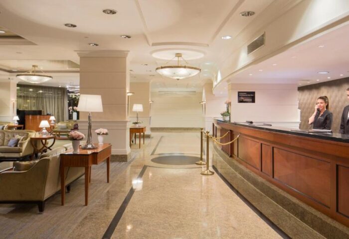 InterContinental Budapest lobby. A gay-friendly, pet-friendly hotel. Reception desk with staff, elegant seating area. Luxury travel.