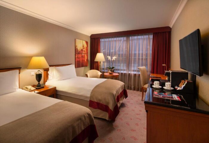 InterContinental Budapest hotel room. Gay-friendly, pet-friendly accommodation with twin beds, desk, TV and city view. Ideal for LGBTQ+ travelers.
