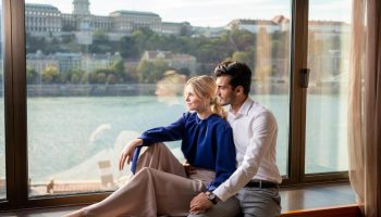 InterContinental Budapest: Couple at gay-friendly, pet-friendly hotel. Danube view from room. Budapest travel for gay men.