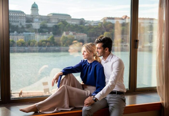 InterContinental Budapest: Couple at gay-friendly, pet-friendly hotel. Danube view from room. Budapest travel for gay men.