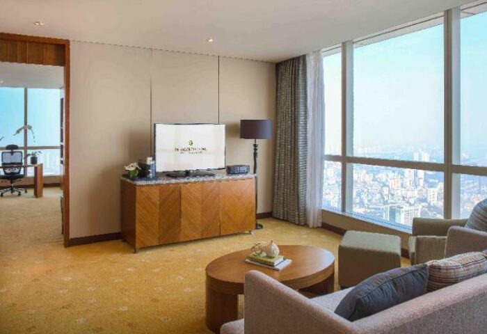 InterContinental Hanoi Landmark72 gay-friendly hotel room. Living area with sofa, TV, and city view. Luxury travel for gay men in Hanoi.