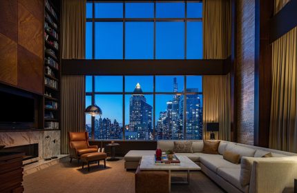 InterContinental New York Times Square gay-friendly hotel suite at night. NYC skyline view from luxury room. Gay travel advice.