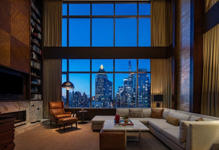 InterContinental New York Times Square gay-friendly hotel suite at night. NYC skyline view from luxury room. Gay travel advice.