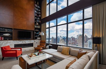 InterContinental New York Times Square gay-friendly hotel suite. NYC skyline view, living room, and modern design. Luxury gay travel.