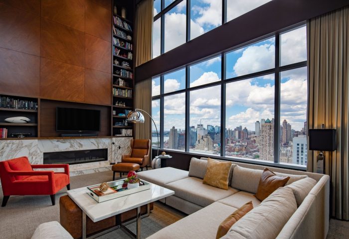 InterContinental New York Times Square gay-friendly hotel suite. NYC skyline view, living room, and modern design. Luxury gay travel.