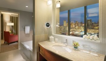 InterContinental San Francisco gay-friendly hotel bathroom. Vanity with city view. Upscale lodging for gay men's travel advice.
