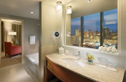 InterContinental San Francisco gay-friendly hotel bathroom. Vanity with city view. Upscale lodging for gay men's travel advice.