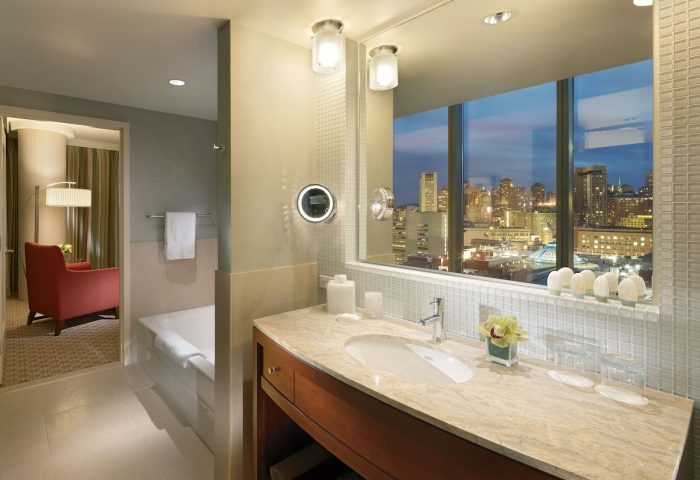 InterContinental San Francisco gay-friendly hotel bathroom. Vanity with city view. Upscale lodging for gay men's travel advice.