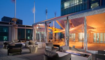 InterContinental San Francisco gay-friendly hotel patio. Outdoor lounge area with fire pits, chairs, and tented dining. Gay travel.