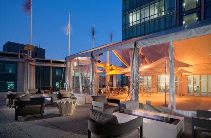 InterContinental San Francisco gay-friendly hotel patio. Outdoor lounge area with fire pits, chairs, and tented dining. Gay travel.