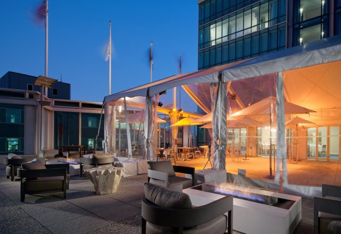 InterContinental San Francisco gay-friendly hotel patio. Outdoor lounge area with fire pits, chairs, and tented dining. Gay travel.