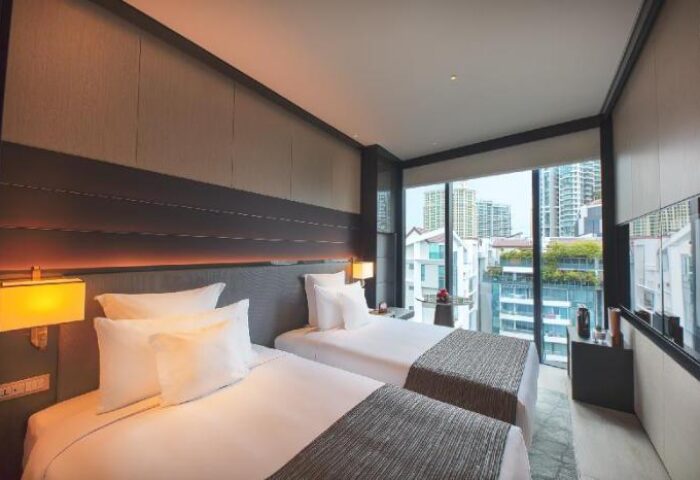 InterContinental Singapore Robertson Quay gay-friendly hotel room. Two beds, city view. Modern design, luxury accommodations for gay travelers.