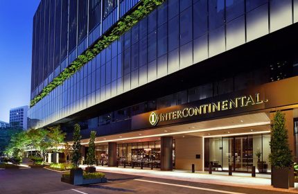 InterContinental Singapore Robertson Quay, a gay-friendly hotel. Facade of the luxury hotel at night, with its entrance and logo visible.