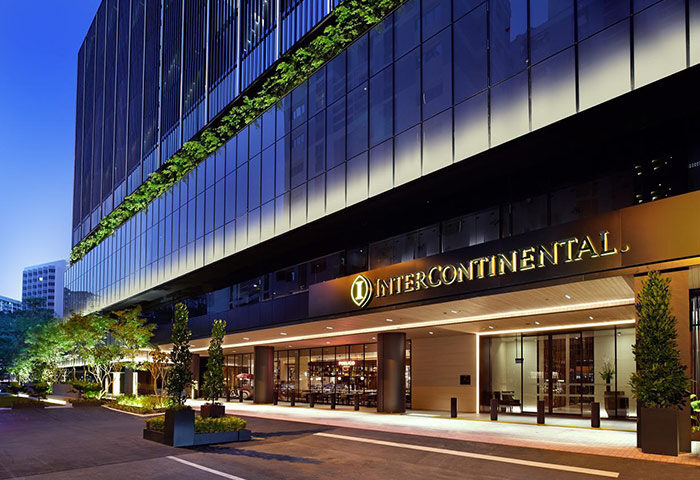 InterContinental Singapore Robertson Quay, a gay-friendly hotel. Facade of the luxury hotel at night, with its entrance and logo visible.