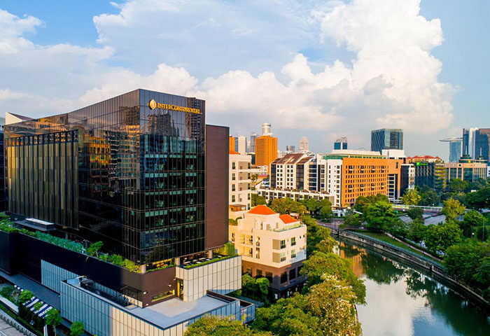 InterContinental Singapore Robertson Quay, a gay-friendly hotel. Exterior view of the hotel, river, and cityscape. Singapore travel.