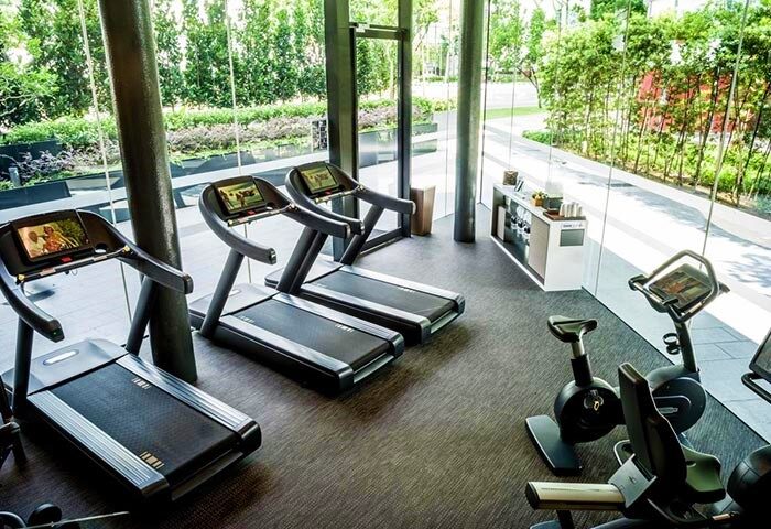 Gym at Gay-Friendly InterContinental Singapore Robertson Quay. Treadmills and exercise bikes with green view. Fitness for gay men travelers.