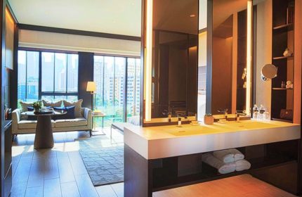 InterContinental Singapore Robertson Quay gay-friendly hotel room. Modern bathroom, double sink, and city view. Luxury travel for gay men.