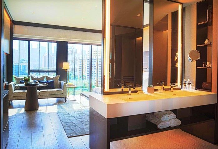 InterContinental Singapore Robertson Quay gay-friendly hotel room. Modern bathroom, double sink, and city view. Luxury travel for gay men.