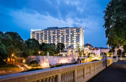 InterContinental Wien, a gay-friendly hotel. View of the hotel at dusk. A great choice for gay travelers visiting Vienna, Austria.