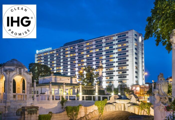 InterContinental Wien, a gay-friendly hotel. Exterior view at dusk with IHG Clean Promise logo. Vienna travel for gay men.