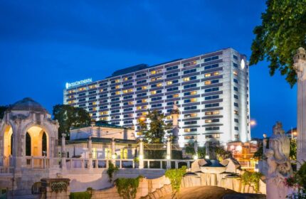 InterContinental Wien, a gay-friendly hotel. View of the hotel at night, with illuminated windows. Vienna travel advice for gay men.
