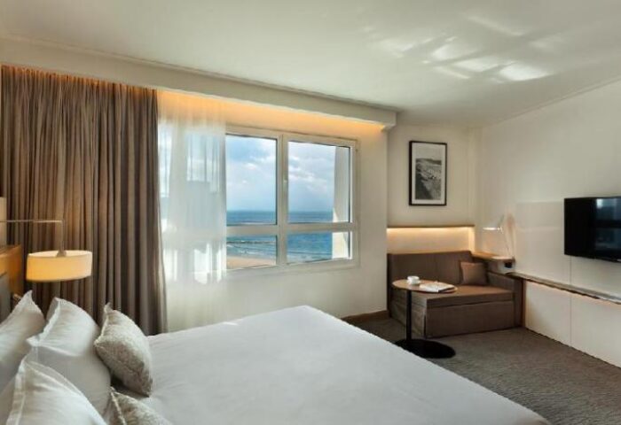 Isrotel Tower Hotel room, gay-friendly stay. Beach view from window. Modern design, comfy bed. Perfect for gay travel in Tel Aviv.
