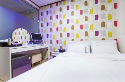Itaewon A One Hotel room. Gay-friendly hotel in Seoul, South Korea. Room with double bed, desk, colorful wallpaper. Modern, clean, and comfortable.