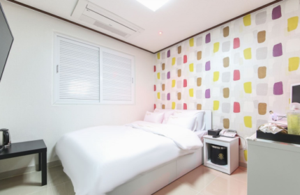 Itaewon A One Hotel room. Gay-friendly hotel in Seoul, South Korea. Clean, modern interior with colorful wall design, bed, desk, and TV.