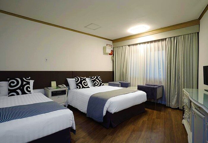 Itaewon Crown Hotel room. Gay-friendly hotel with twin beds, modern decor, and wooden floors. Ideal for gay travelers in Itaewon, South Korea.