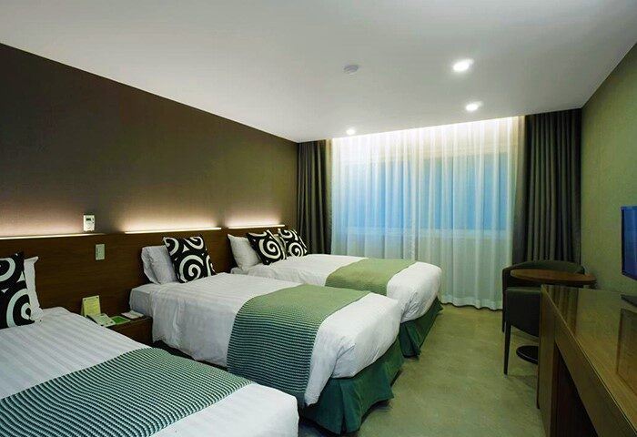Itaewon Crown Hotel room with three beds. Gay-friendly hotel in Seoul, South Korea. Modern decor, comfortable for gay travelers.