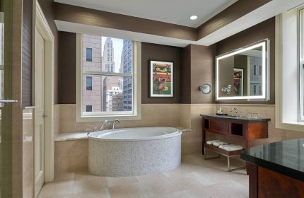 JW Marriott Chicago gay-friendly hotel bathroom with a large tub, vanity, and city view. Upscale design and amenities for gay travelers.