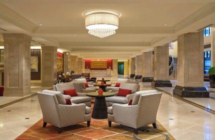 JW Marriott Chicago's elegant lobby. This gay-friendly hotel features stylish seating areas, marble floors, and a grand chandelier.