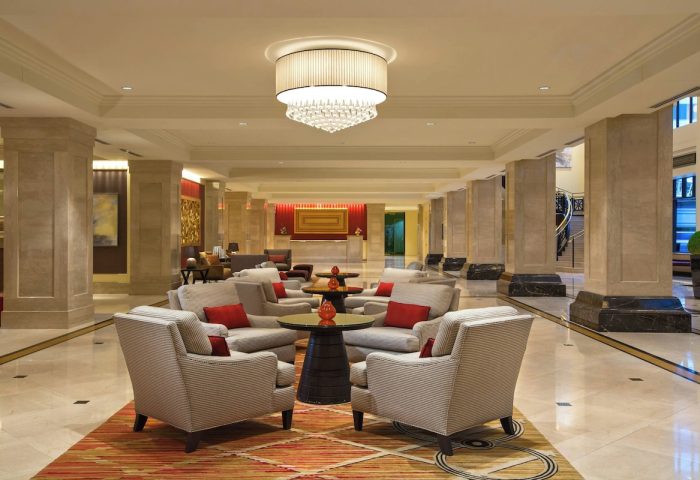 JW Marriott Chicago's elegant lobby. This gay-friendly hotel features stylish seating areas, marble floors, and a grand chandelier.