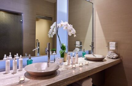 JW Marriott Desert Springs Resort & Spa bathroom. Gay-friendly hotel with double sinks, orchid, and spa products. Luxury travel.