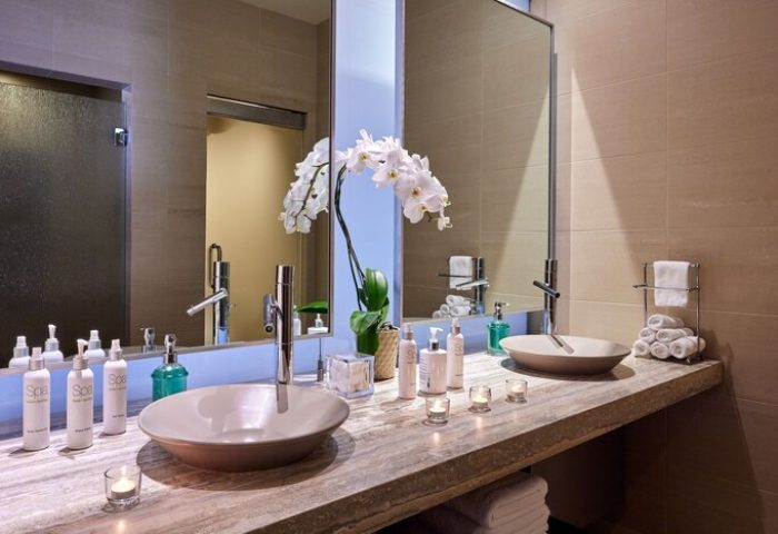 JW Marriott Desert Springs Resort & Spa bathroom. Gay-friendly hotel with double sinks, orchid, and spa products. Luxury travel.