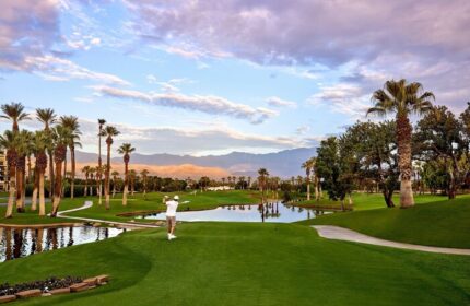 JW Marriott Desert Springs Resort & Spa golf course. Man teeing off. Palm trees, mountains, water features. Gay-friendly hotel.