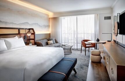 JW Marriott Desert Springs Resort & Spa gay-friendly hotel room. King bed, seating area, and balcony view. Luxury travel for gay men.