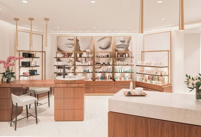 JW Marriott Parq Vancouver's spa. Beauty products are displayed on shelves with images of faces above. Gay-friendly hotel with nice amenities.