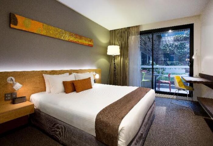 Gay-Friendly Hotel Jasper Boutique Hotel room. Modern design, king bed, balcony with chairs. Ideal gay travel accommodation.