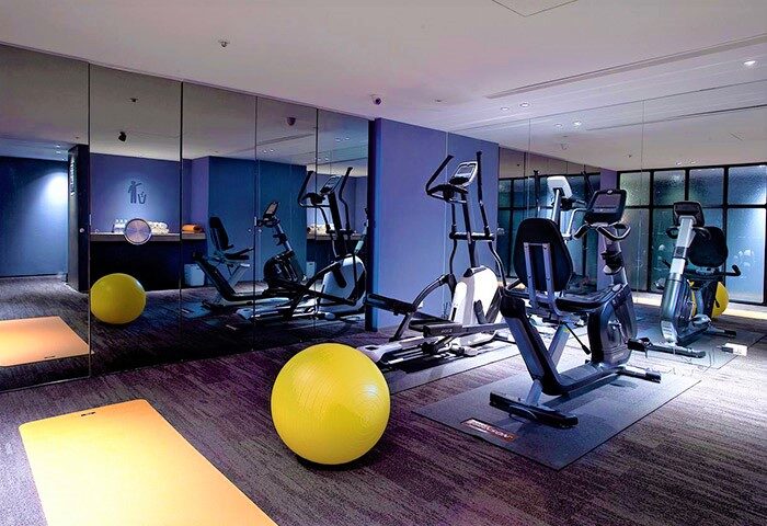 Gym at Just Sleep Hotel Ximending, a gay-friendly hotel. Exercise equipment, yoga mat, and fitness ball are visible. Perfect for gay travelers.