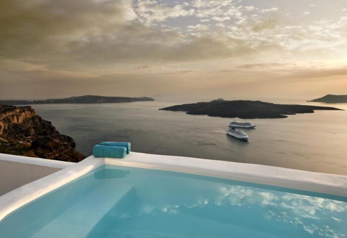 Kamares Apartments gay-friendly hotel view: Pool with ocean view, islands, and cruise ships. Ideal gay men travel destination.