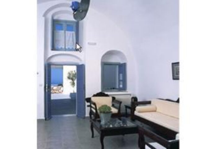Kamares Apartments interior. Gay-friendly hotel room with white walls, blue doors, & traditional Greek furniture. Ideal for gay travel.