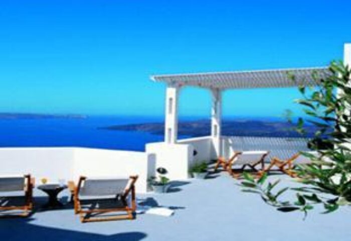 Kamares Apartments: Gay-friendly hotel terrace view. Deck chairs overlook the Aegean Sea. Ideal for gay men's travel in Santorini, Greece.