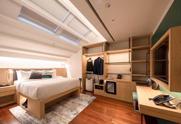 KēSa House by Oakwood: Gay-friendly hotel room. Modern design with bed, desk, closet, & skylights. Unlimited Collection for discerning travelers.
