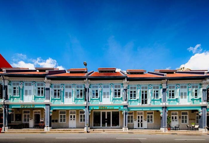 KēSa House by Oakwood, a gay-friendly hotel. Facade of the Unlimited Collection hotel with light blue walls and red tiled roofs in Singapore.