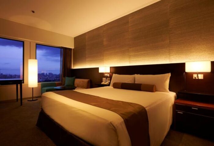 Keio Plaza Hotel Tokyo bedroom. Gay-friendly hotel room with king bed, bedside tables, and city view. Ideal lodging for gay travelers in Tokyo.
