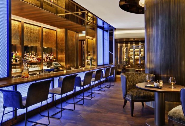 Bar area at the gay-friendly Kempinski Hotel Corvinus Budapest. Elegant seating, cocktails, and a stylish ambiance. Pet-friendly hotel.