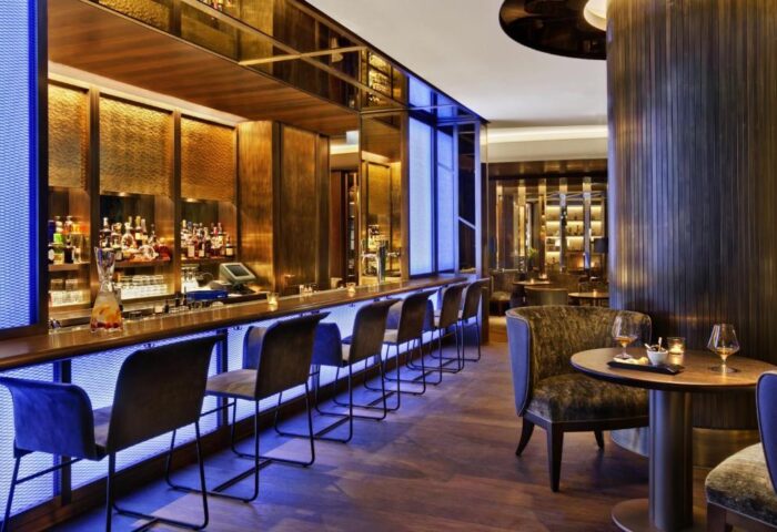 Bar area at the gay-friendly Kempinski Hotel Corvinus Budapest. Elegant seating, cocktails, and a stylish ambiance. Pet-friendly hotel.